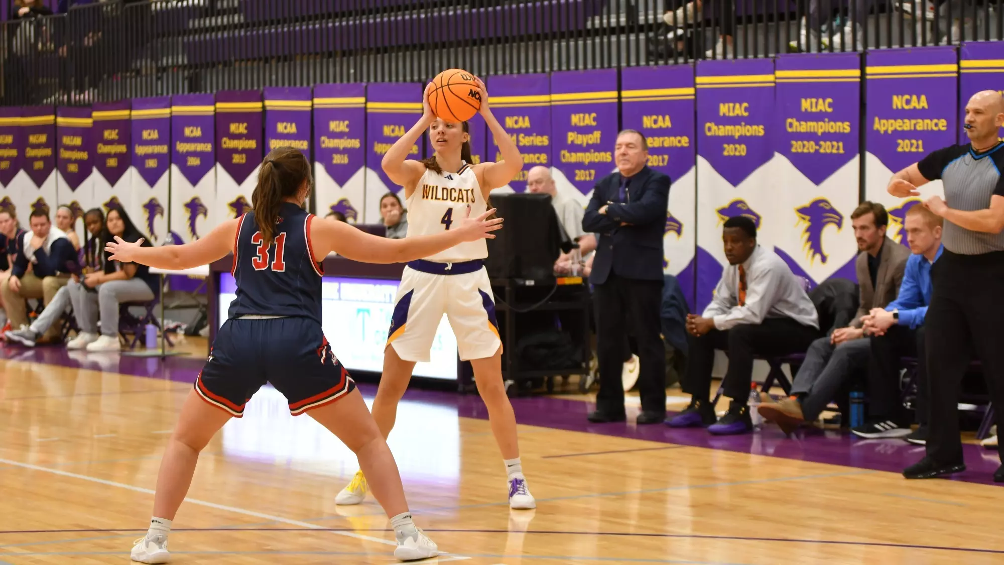 Greta Schimnowski with basketball being defended by Saint Mary