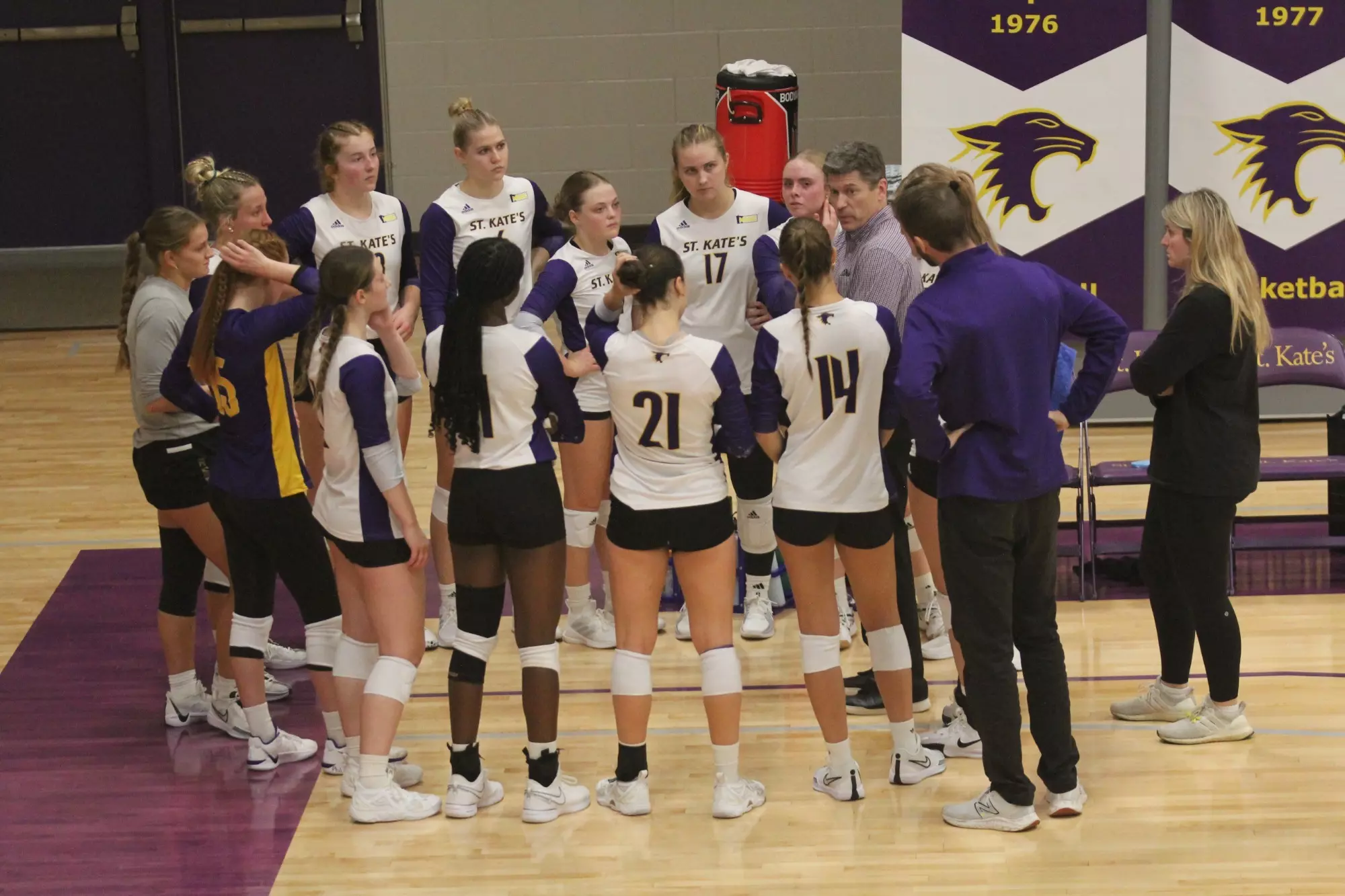 Volleyball Team in huddle at Butler Center