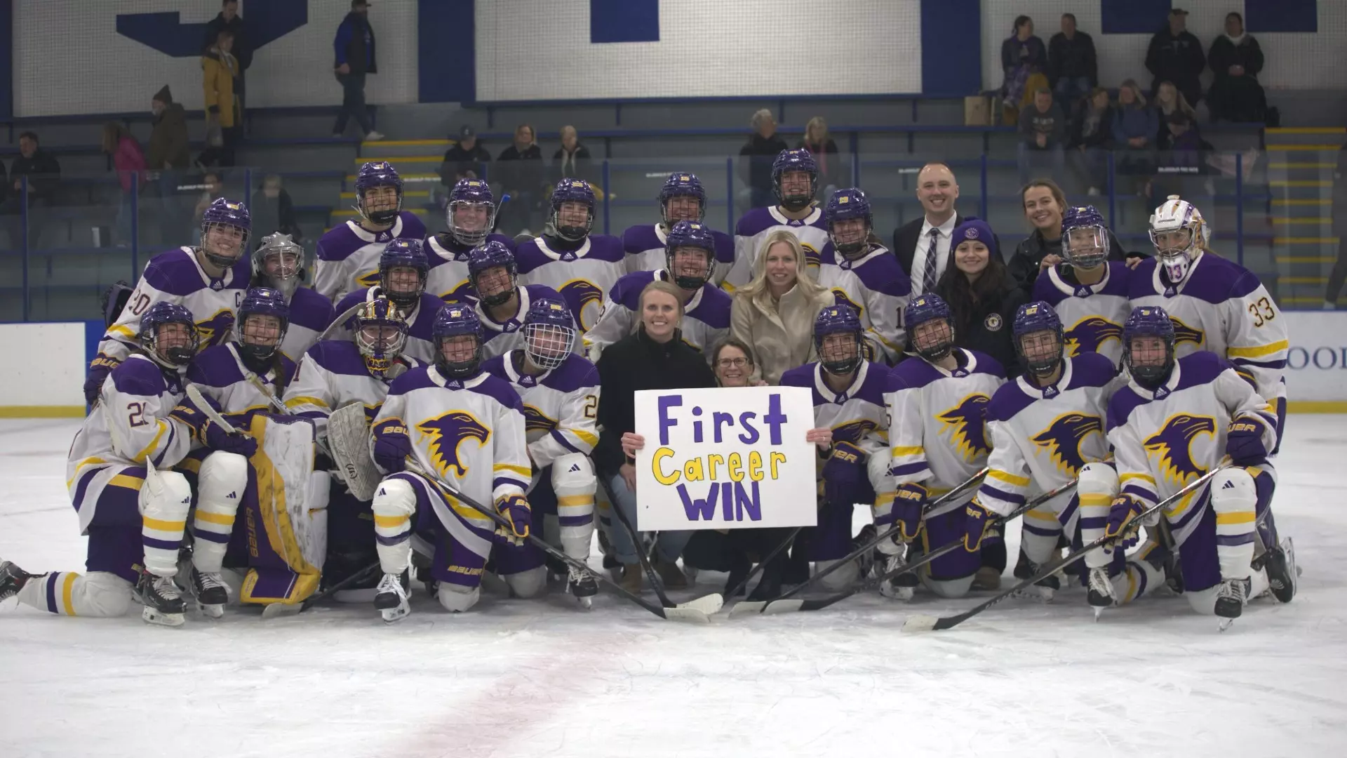 Hockey team celebrating first career coaching win