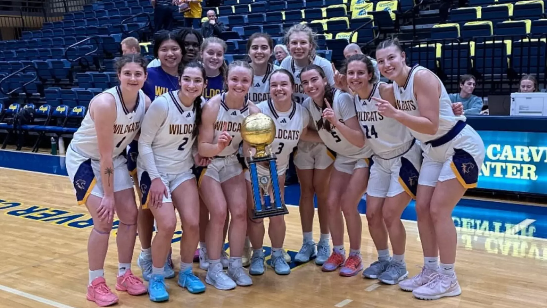 Basketball team with Hyatt Place Tournament Championship Trophy