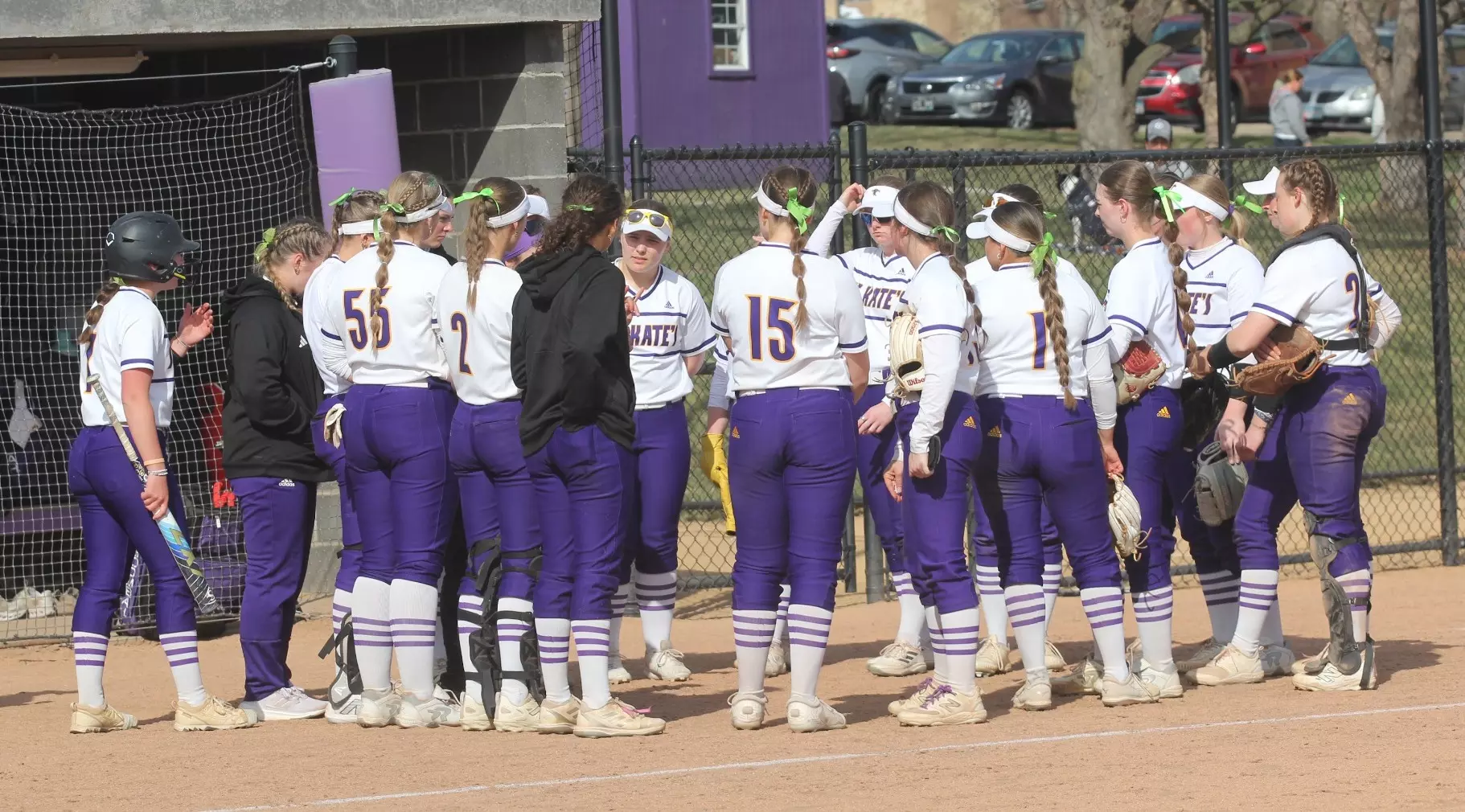 Softball team huddle at home